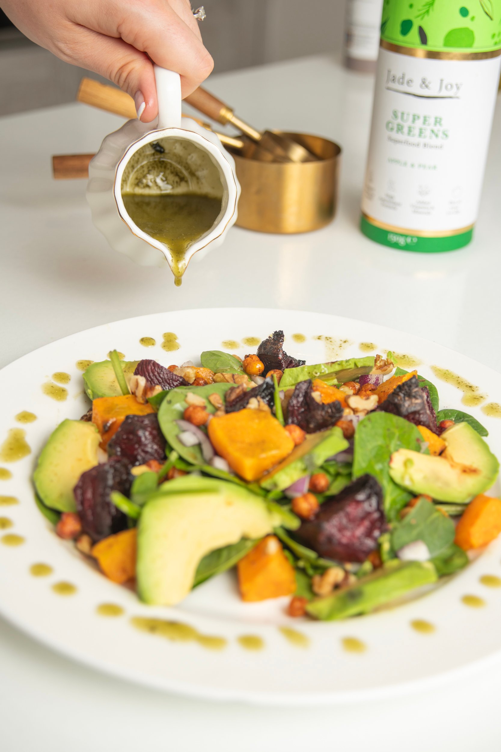 Salad Dressing with Super Greens pouring over Salad.