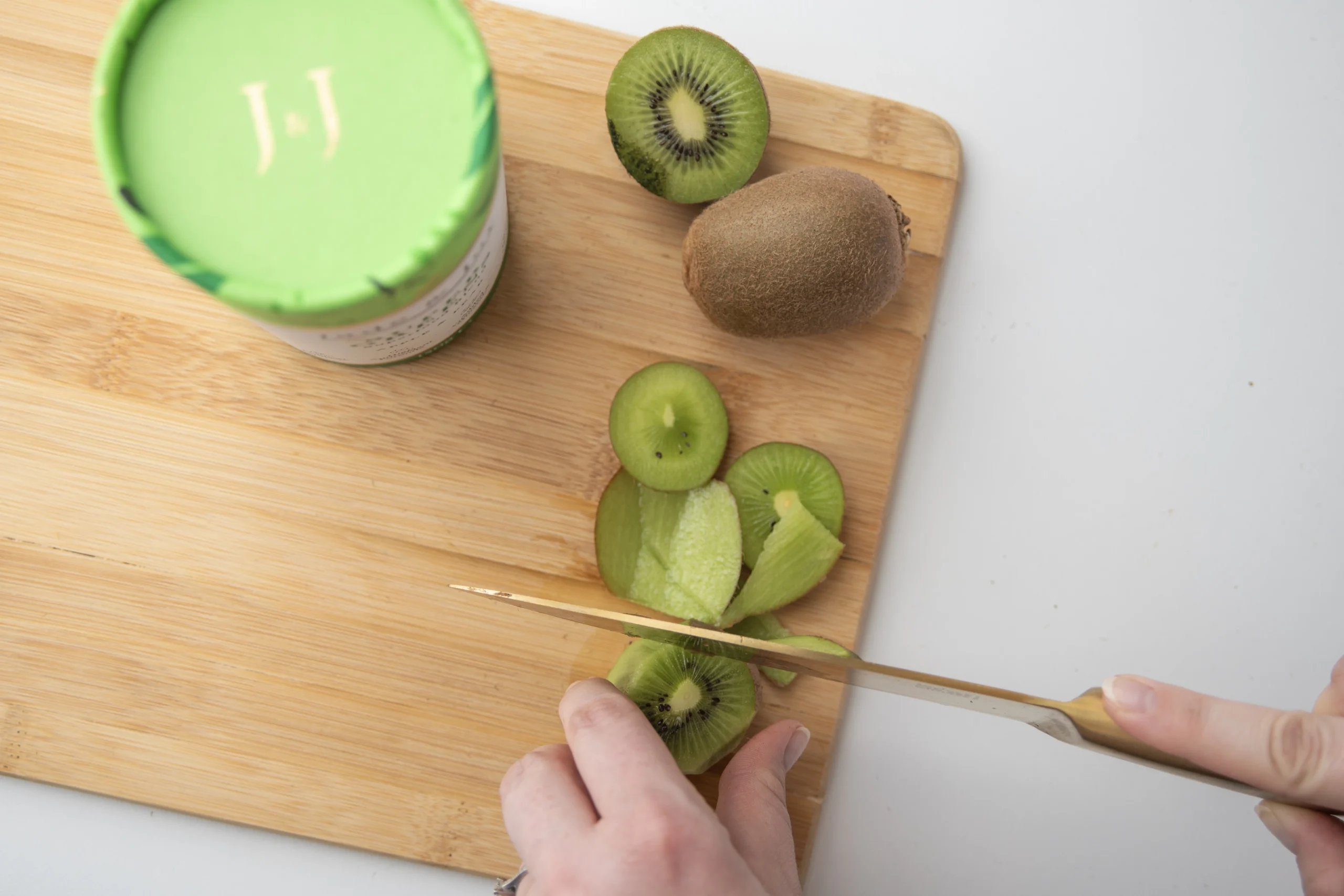 Chopping a kiwi for a super greens smoothie