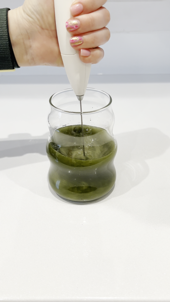 Whisking Super Greens in a glass