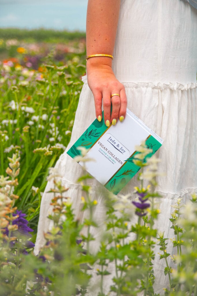 Jade & Joy Vegan Collagen Protein Bars in a flower field